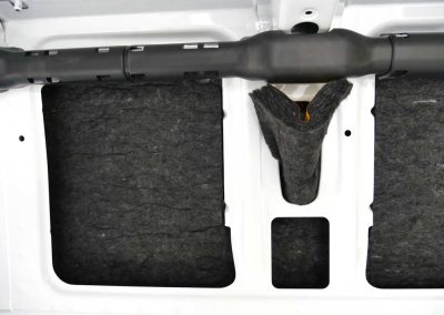 Close-up of AutoPly insulation kit installed behind wall support structure in Mercedes-Benz Sprinter 170 van