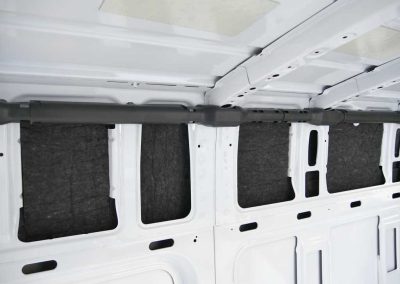 Interior side wall installation of AutoPly insulation kit in Mercedes-Benz Sprinter 170 van build